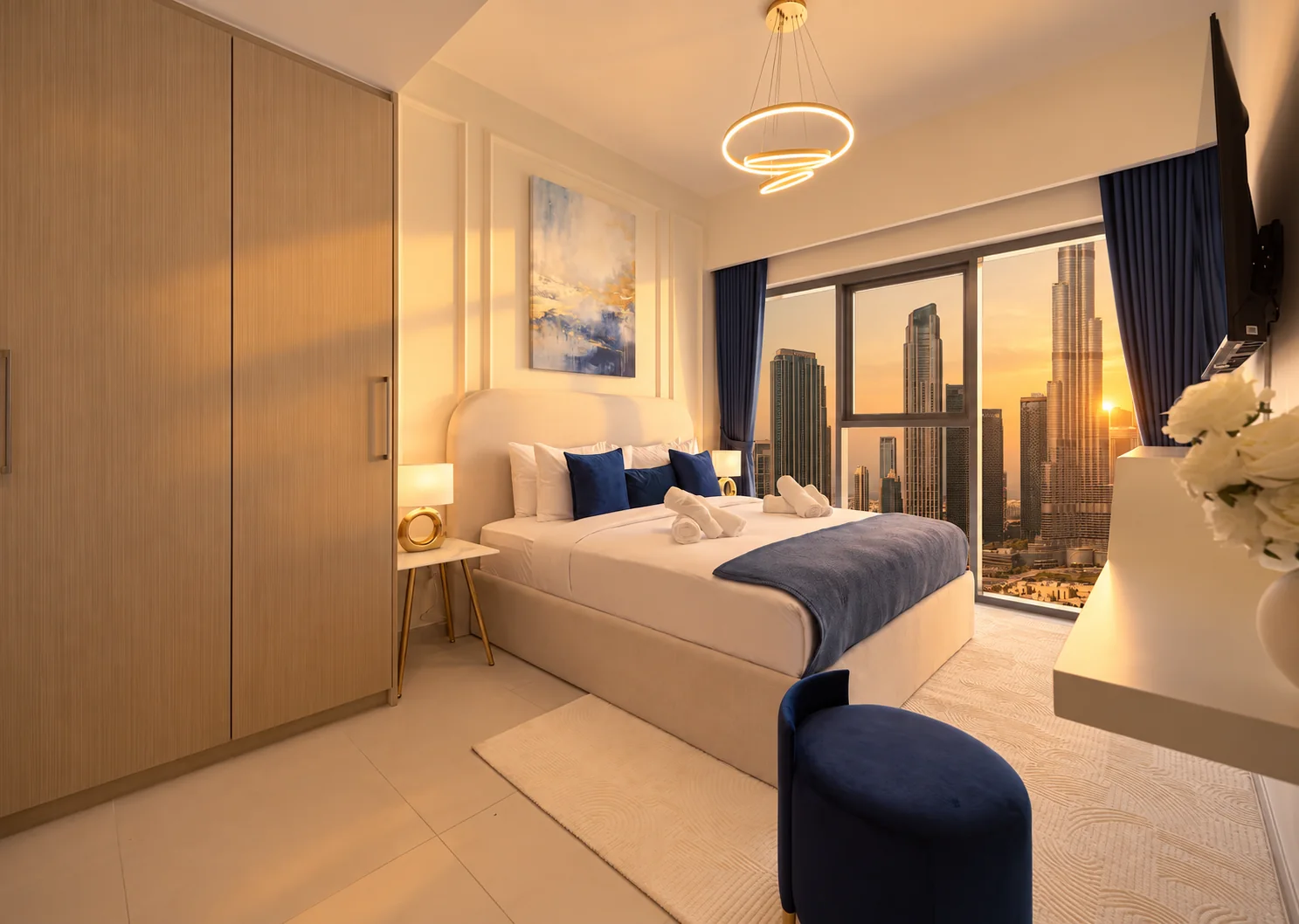Navy-accented bedroom with wardrobe and Downtown Dubai views